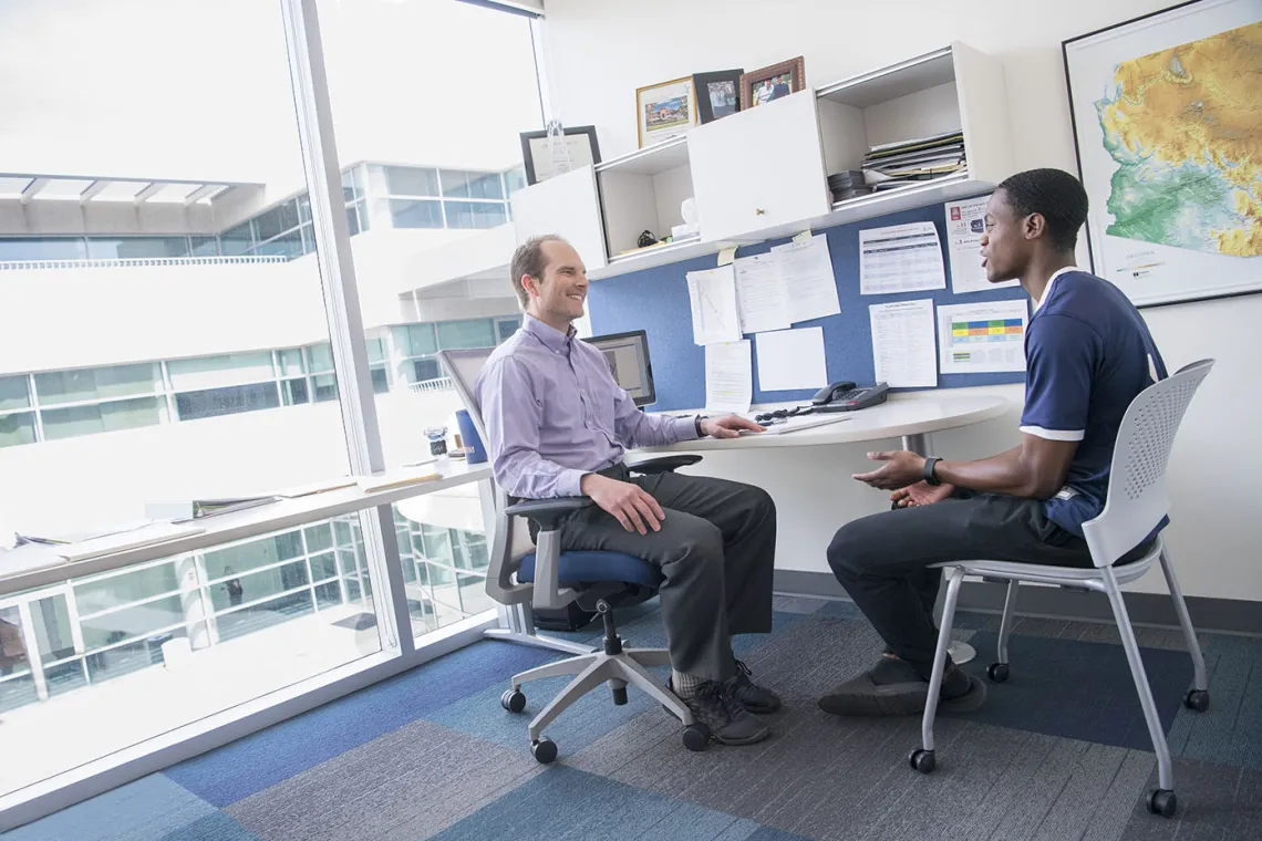 Student talking to advisor.